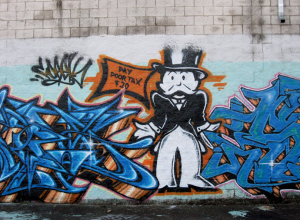 Graffiti featuring Monopoly Man asking for taxes.