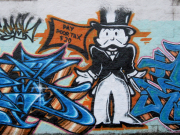 Graffiti featuring Monopoly Man asking for taxes.