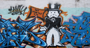 Graffiti featuring Monopoly Man asking for taxes.