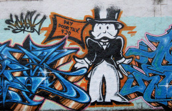 Graffiti featuring Monopoly Man asking for taxes.