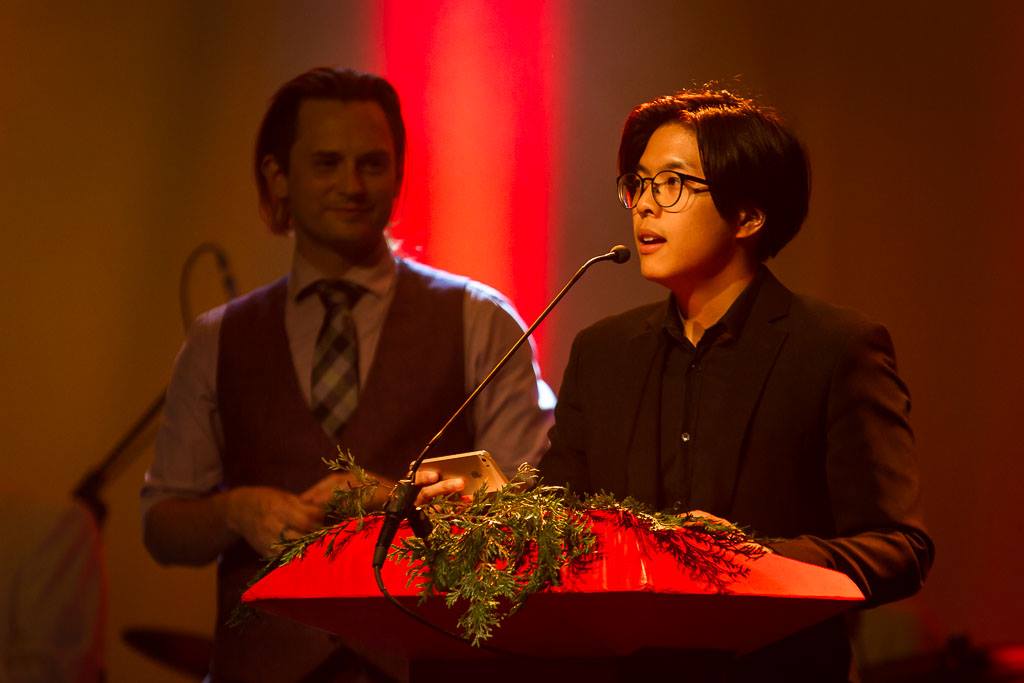 Milton Lim speaking into a mic at a podium. 