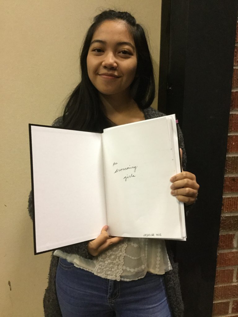 Jaquie holds a copy of the script for The Drowning Girls, she chose this play for her directing project. 