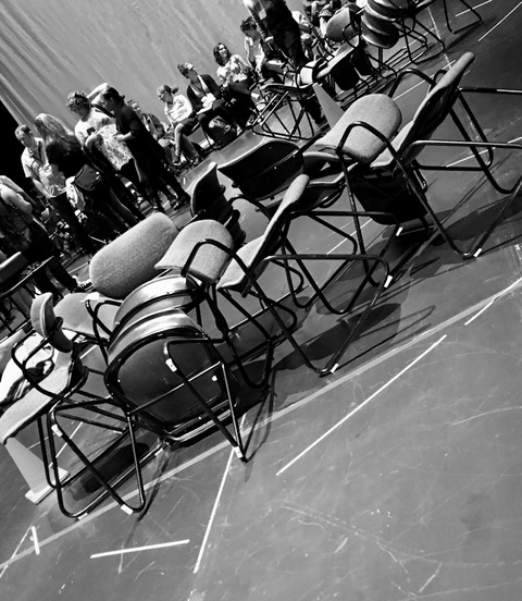 Photo of chairs, some with people in them, taken by Brad Rothbart.